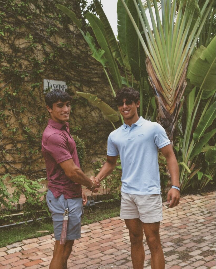 Kyle Abellar wearing sunglasses and a cap at the beach